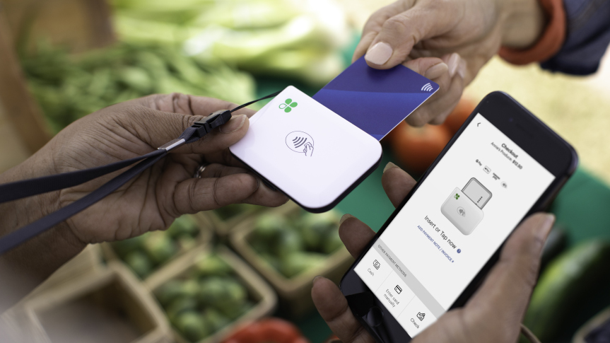 Customer tapping a card on a Clover Go mobile reader
