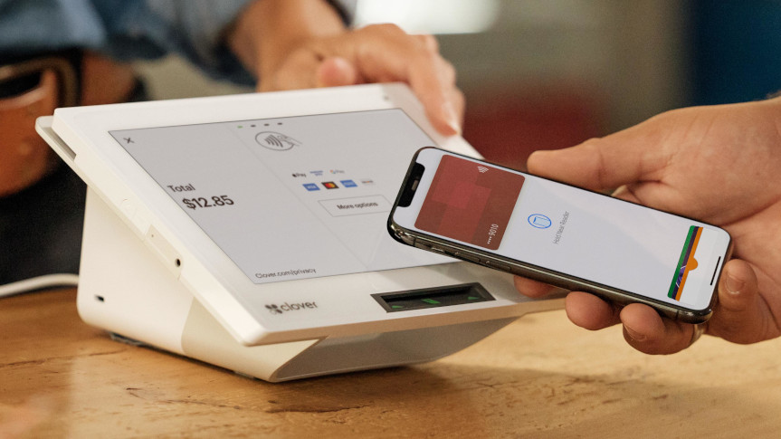Customer using a phone wallet to pay on a Clover Mini